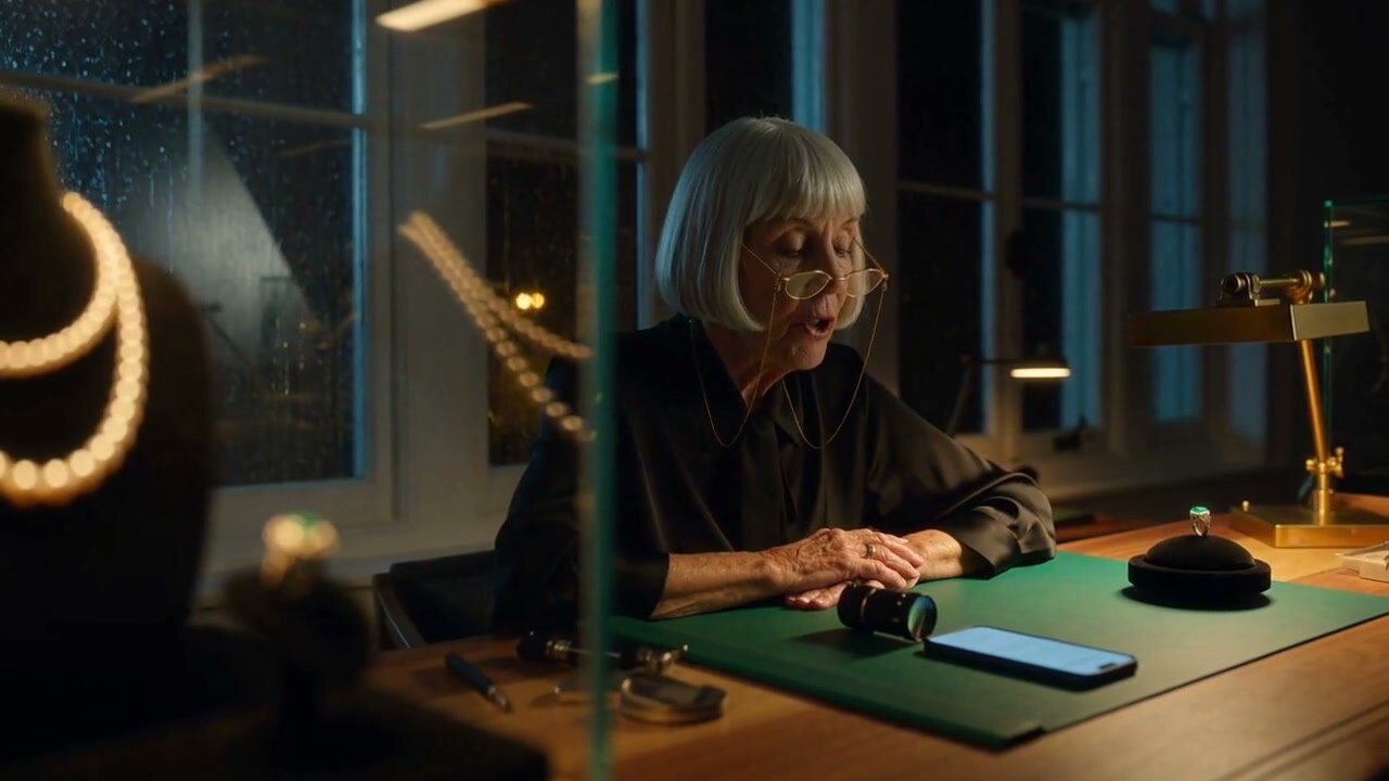 Maison: a jeweller at her desk on a rainy night, pearls in the case