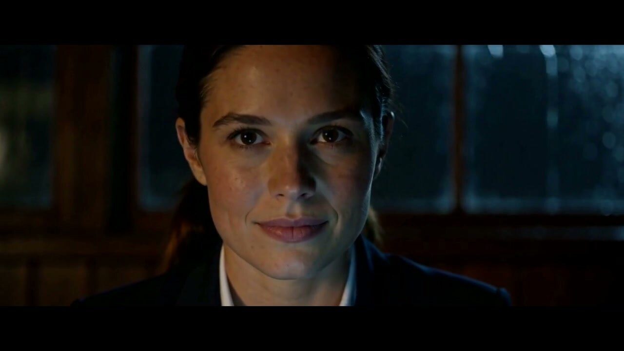 Mia, close-up, in the dark house